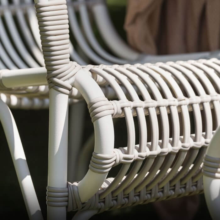 A close up of a white outdoor lounge chair
